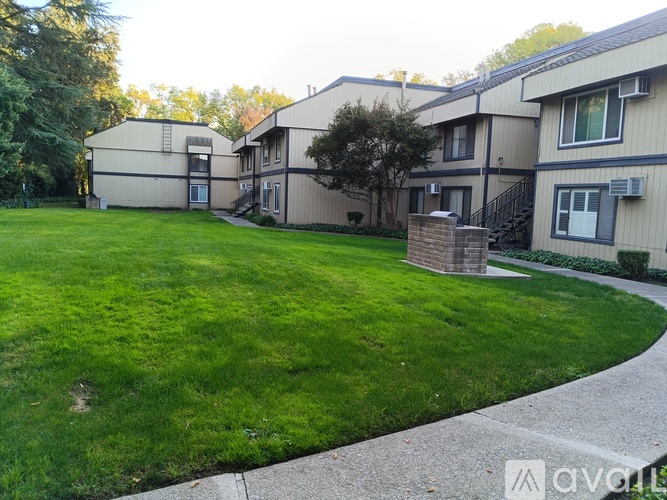 A grassy area in front of apartment buildings.