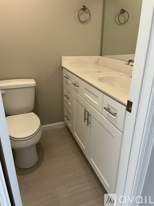 A white toilet sits next to a sink in a bathroom.
