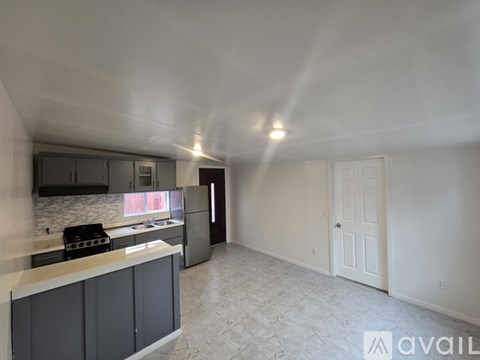 A kitchen with a counter and cabinets is available for rent.