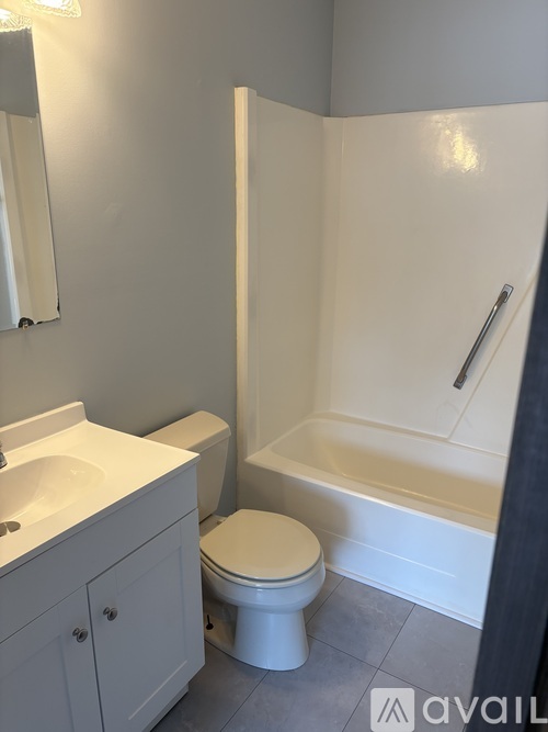 A white toilet sits next to a sink in a bathroom.