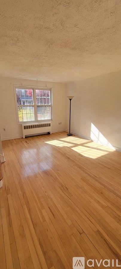 A room with wooden floors and a window.