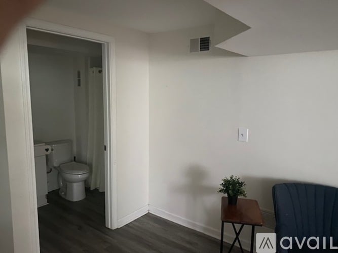A small room with a toilet and a chair.