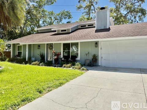 A house with a white garage door and a brown roof.