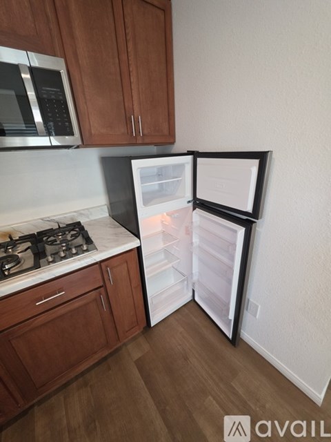 A kitchen with wooden cabinets and a white fridge.