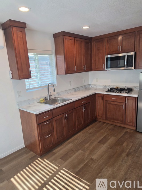 A kitchen with wooden cabinets and a white countertop.