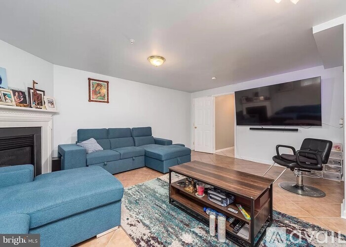 A living room with a blue couch and a coffee table.