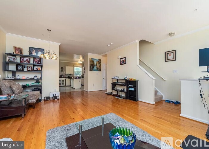 A living room with a brown rug and a blue basket on the coffee table.