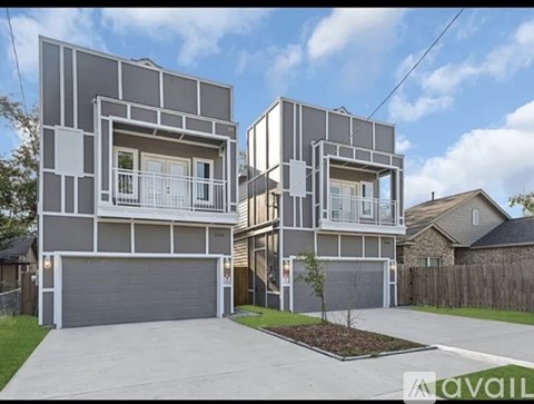 A modern two-story house with a garage is for sale.