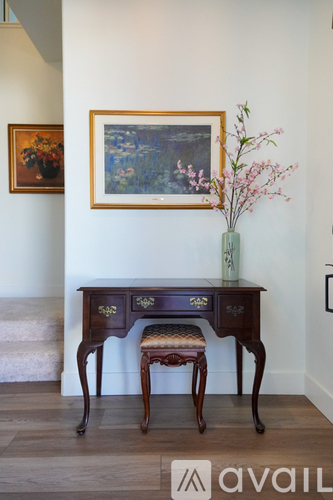 A brown desk with a vase of flowers on top of it.