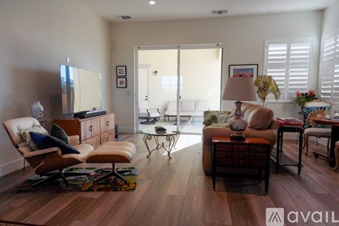 A living room with a brown chair and a brown sofa.