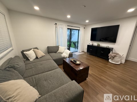 A living room with a grey sofa and a wooden coffee table.