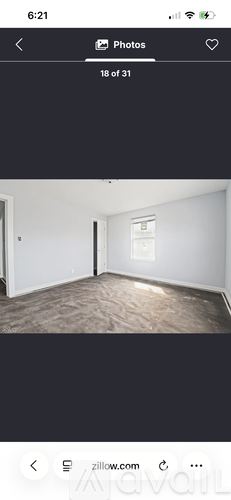 A room with a white wall and a window.