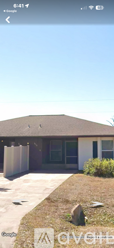 A house with a brown roof and a white garage door.