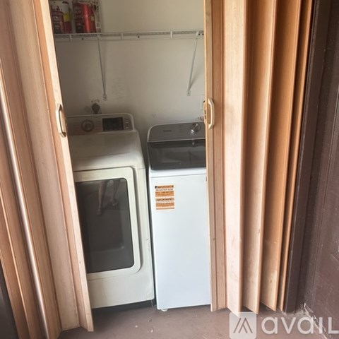 A small kitchen with a white oven and a white fridge.