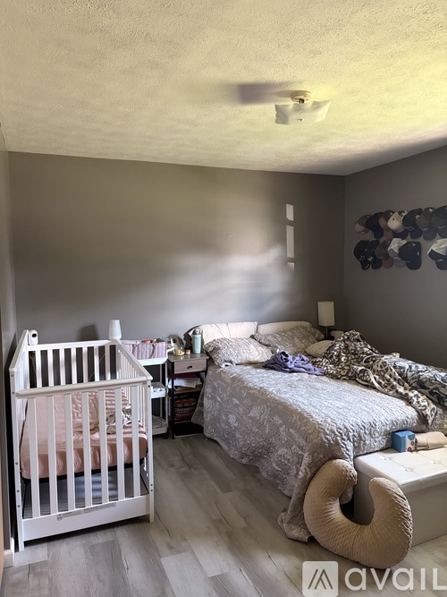 A baby's room with a crib and a bed.
