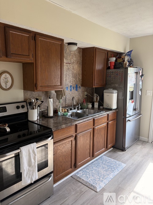 A kitchen with wooden cabinets and a black stove top.
