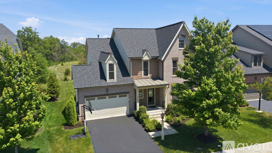 A large house with a driveway in front of it.