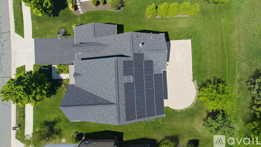 A house with a solar panel on the roof.