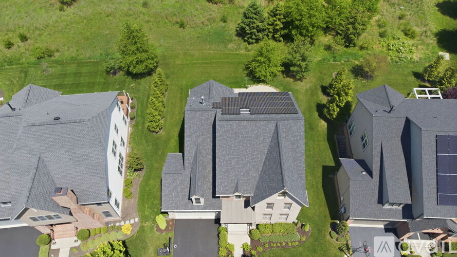A bird's eye view of a residential area with houses and greenery.