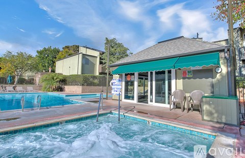 A pool with a sign in front of a building.