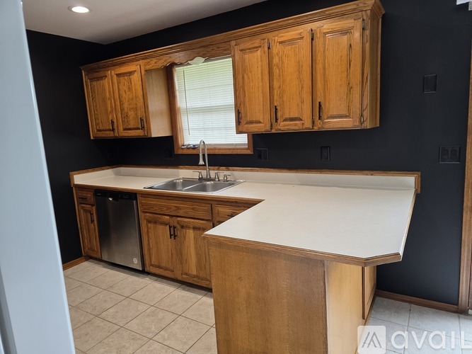 A kitchen with wooden cabinets and a white countertop.