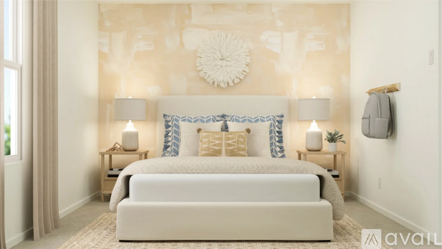 A bedroom with a large bed and a wall hanging.