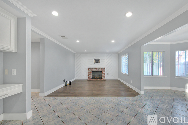 A spacious living room with a fireplace and a television.