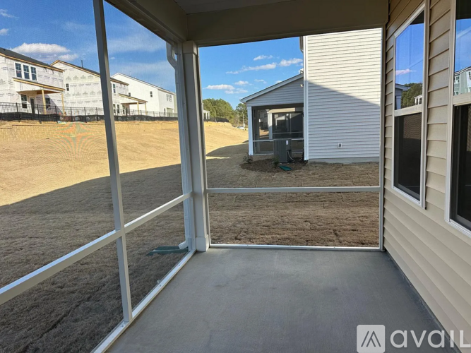 A patio area of a house with a view of other houses in the background.