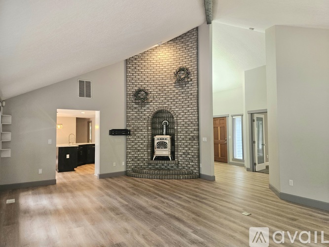 A room with a brick wall and a wreath on it.