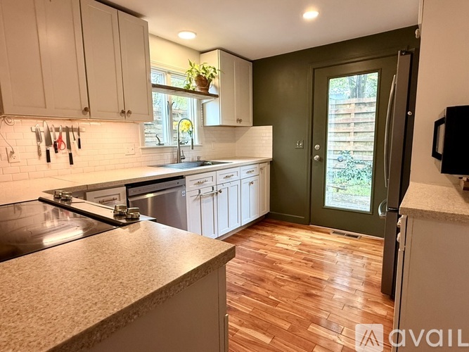 A kitchen with a stove top oven and a sink.