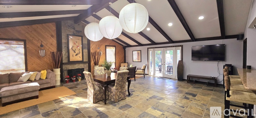 A living room with a fireplace and a television.