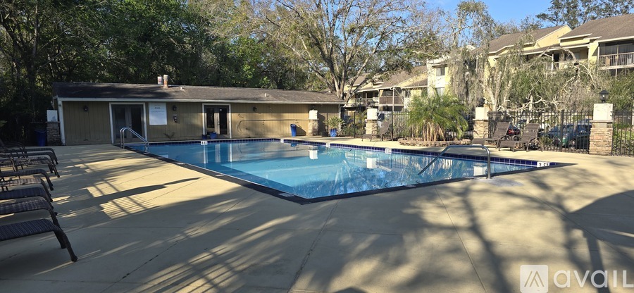 A pool with a house in the background.