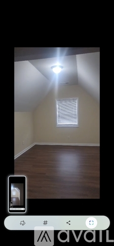 A room with a window and wooden floor.