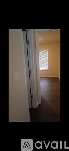 A room with a white door and a window with blinds.