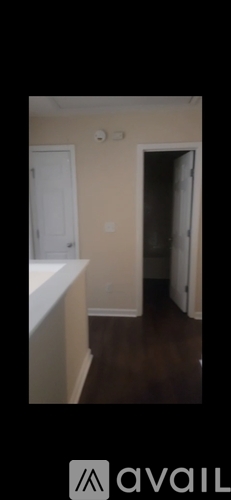A room with a white door and a white countertop.