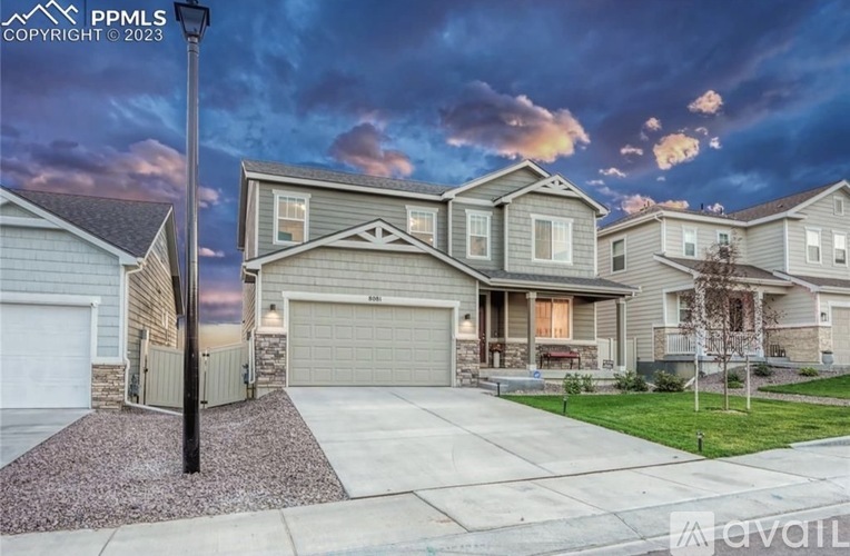 A house with a driveway and a lamp post in front.