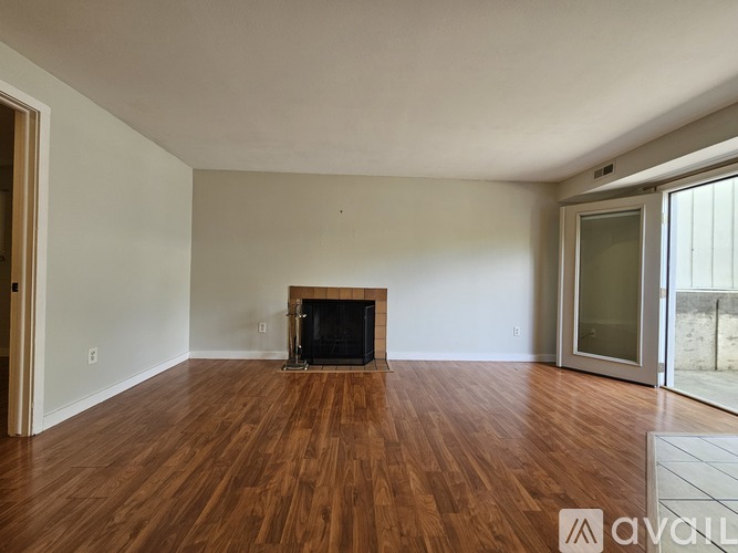 A room with a fireplace and wooden floors.