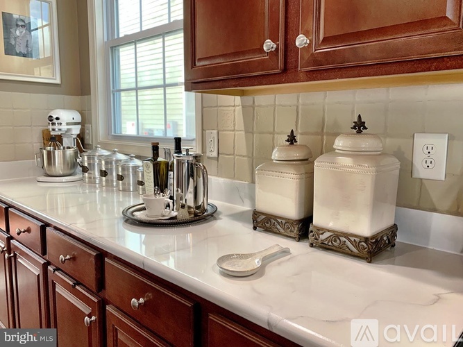 A kitchen with brown cabinets and a white countertop.