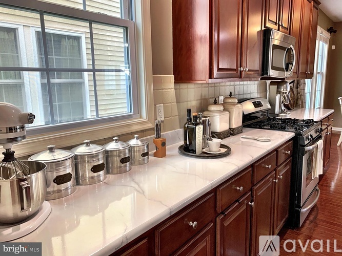 A kitchen with brown cabinets and a white countertop.