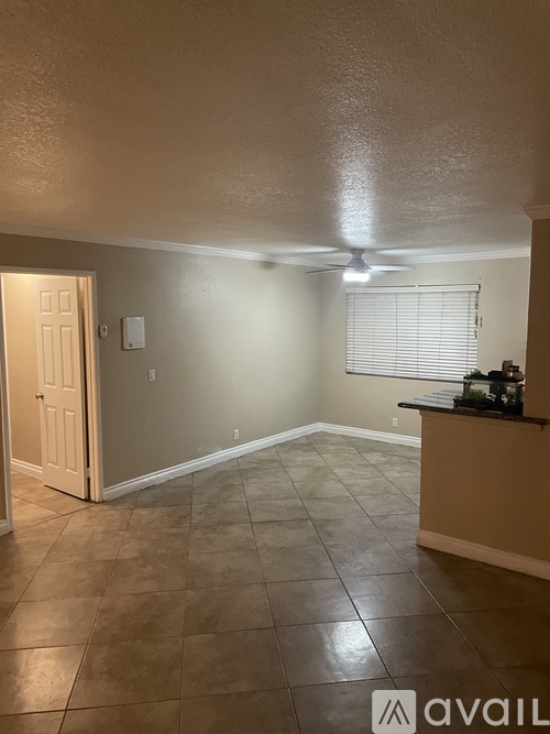 A room with tile flooring and a ceiling fan.