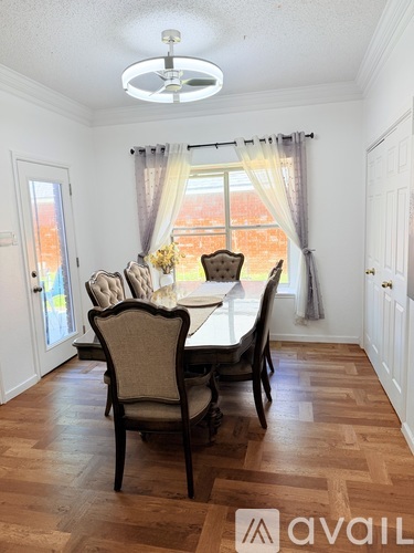 A dining room with a table set for four.