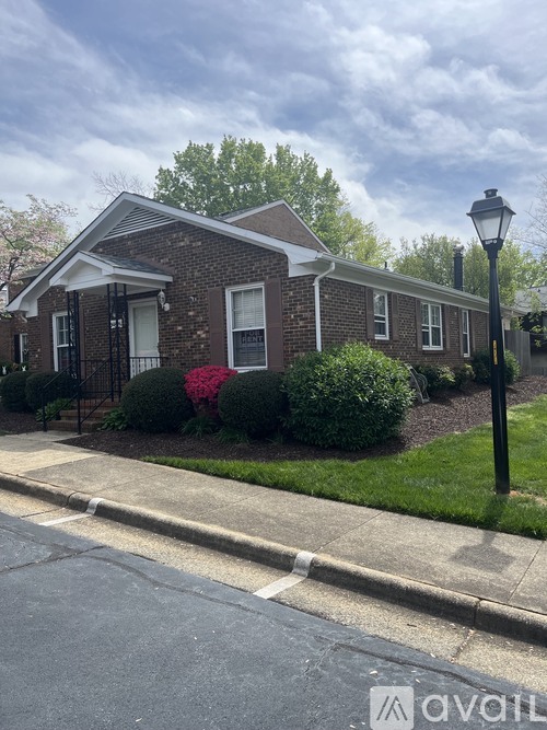A brick house with a lamp post in front.