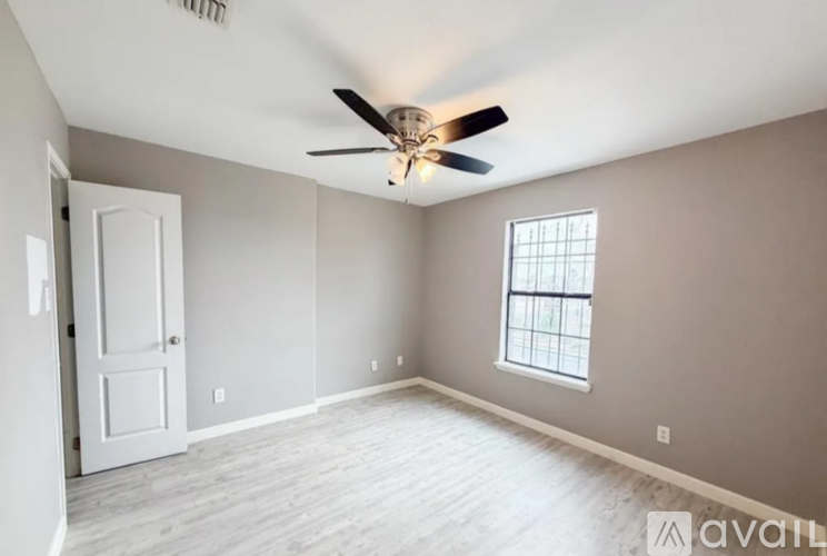 A room with a ceiling fan and a window.