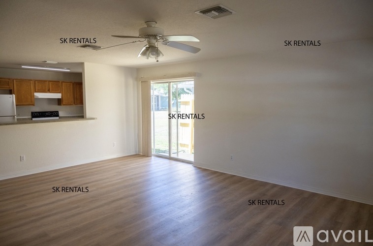 A spacious room with SK Rentals written on the wall.