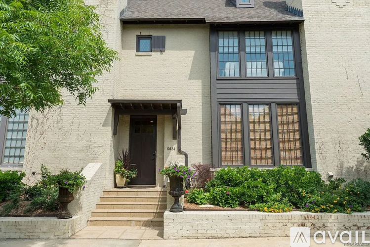 A house with a brown door and windows is for sale.
