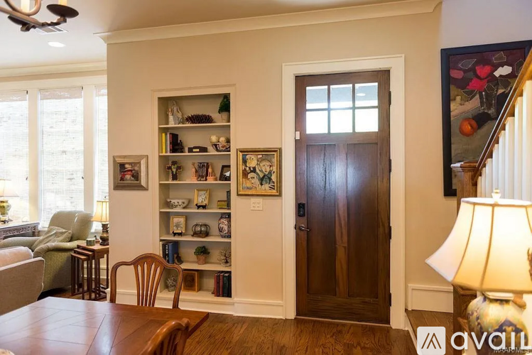 A room with a brown door and a wooden table.