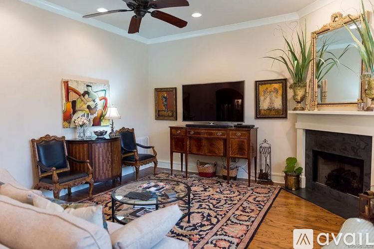 A living room with a fireplace and a television.