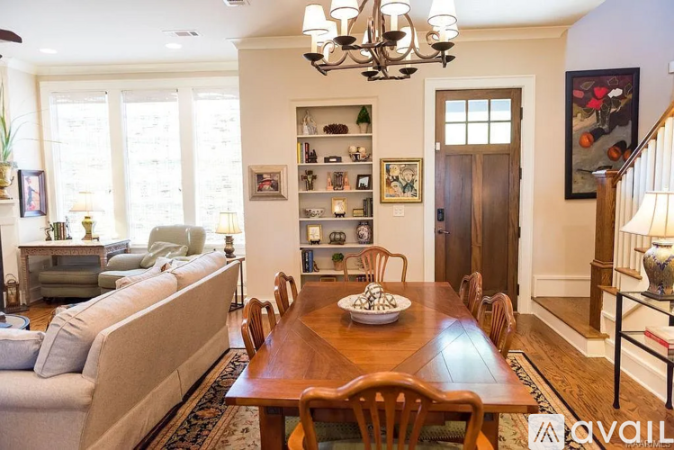A dining room with a wooden table and chairs.
