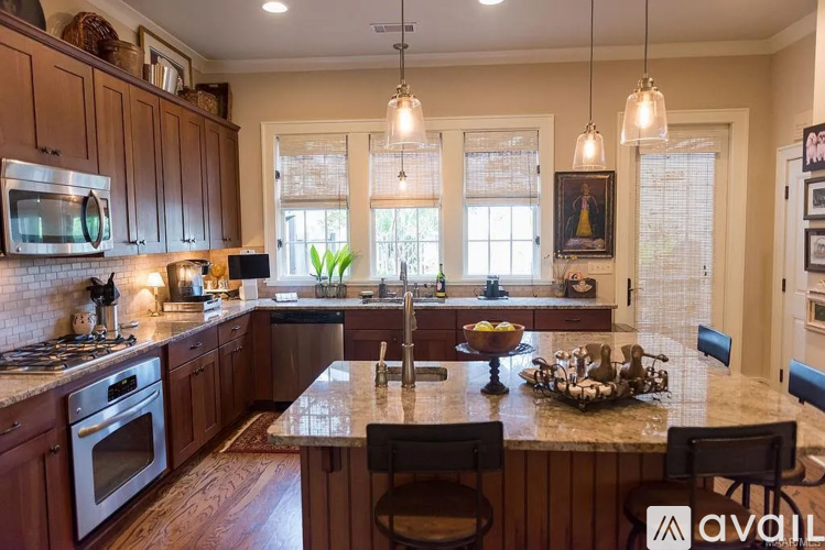 A kitchen with wooden cabinets and a granite countertop.