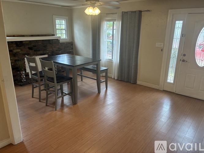 A dining room with a table and chairs.